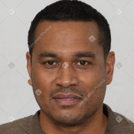 Joyful latino adult male with short  black hair and brown eyes
