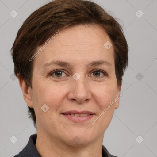 Joyful white adult female with short  brown hair and grey eyes