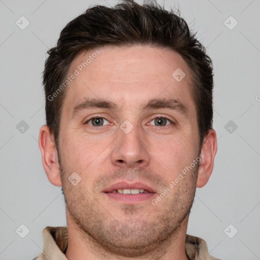 Joyful white young-adult male with short  brown hair and grey eyes