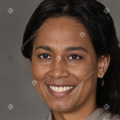 Joyful latino adult female with medium  brown hair and brown eyes
