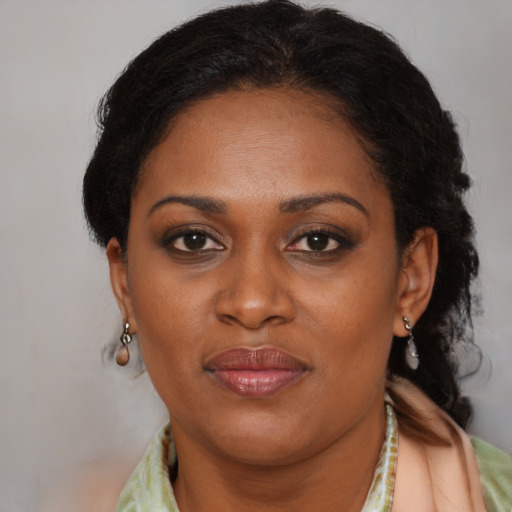 Joyful black adult female with short  brown hair and brown eyes