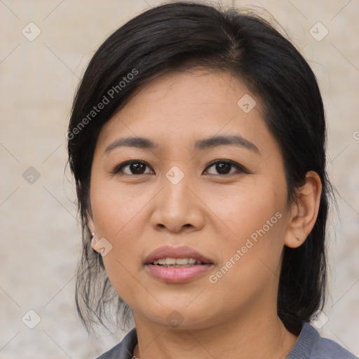 Joyful asian young-adult female with medium  black hair and brown eyes