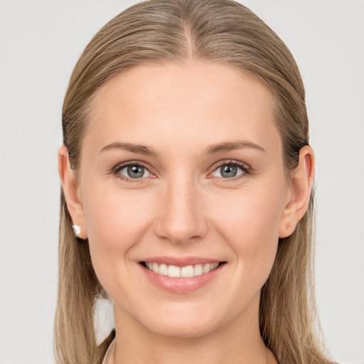 Joyful white young-adult female with long  brown hair and blue eyes