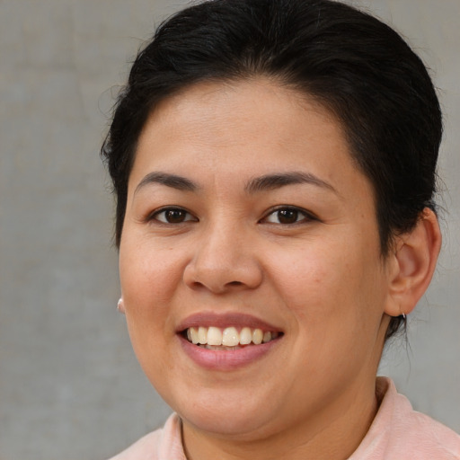 Joyful asian young-adult female with short  brown hair and brown eyes