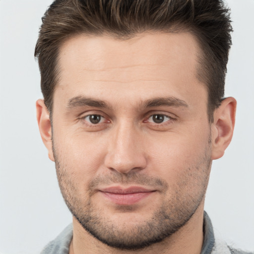 Joyful white adult male with short  brown hair and brown eyes