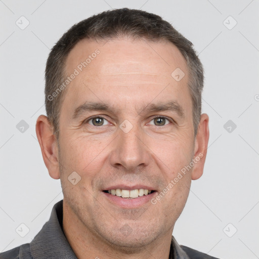 Joyful white adult male with short  brown hair and brown eyes