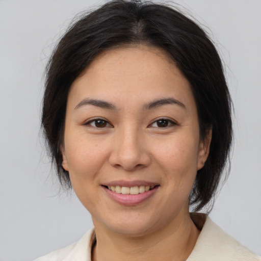 Joyful white young-adult female with medium  brown hair and brown eyes