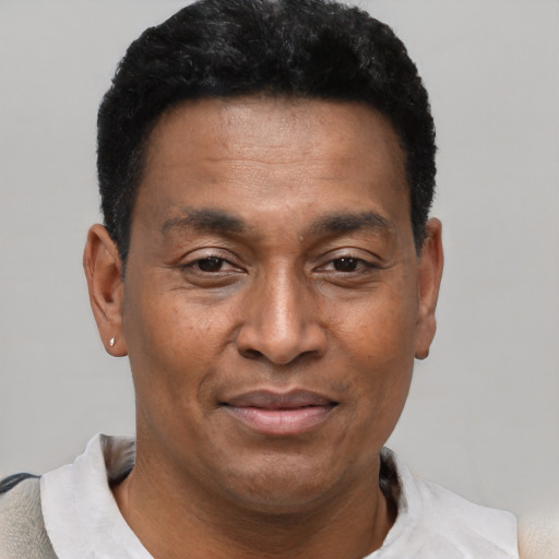 Joyful latino adult male with short  black hair and brown eyes