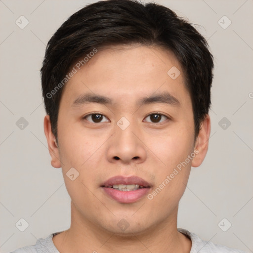 Joyful asian young-adult male with short  brown hair and brown eyes