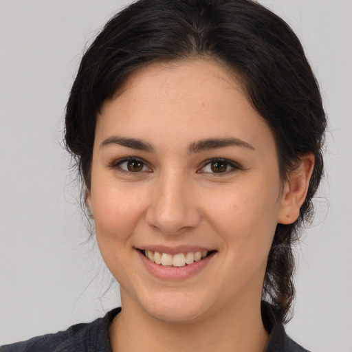 Joyful white young-adult female with medium  brown hair and brown eyes