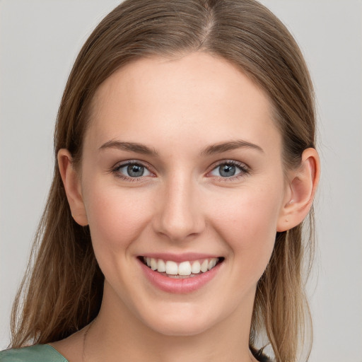 Joyful white young-adult female with long  brown hair and grey eyes