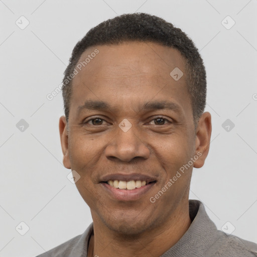 Joyful black young-adult male with short  black hair and brown eyes