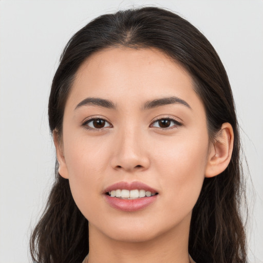 Joyful white young-adult female with long  brown hair and brown eyes