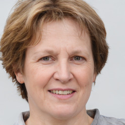 Joyful white adult female with medium  brown hair and grey eyes