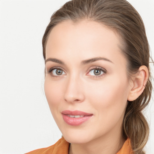 Joyful white young-adult female with long  brown hair and blue eyes