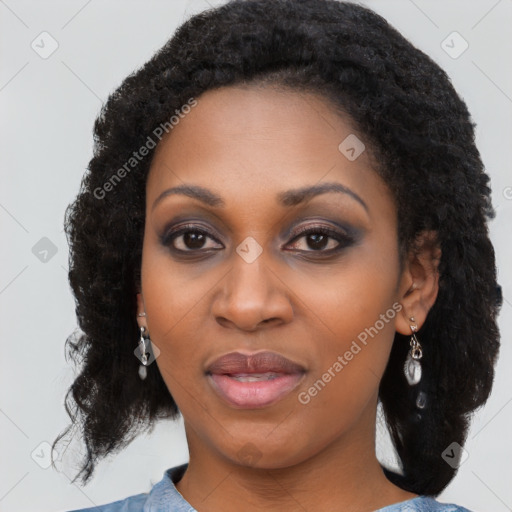 Joyful black young-adult female with long  black hair and brown eyes