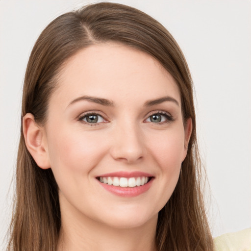 Joyful white young-adult female with long  brown hair and grey eyes