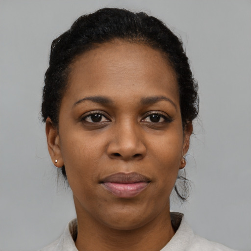 Joyful black young-adult female with short  black hair and brown eyes