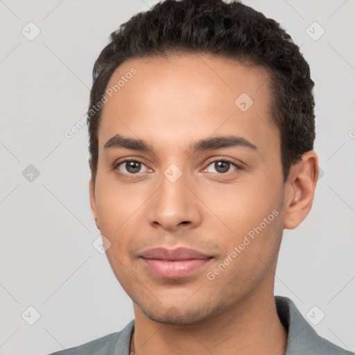 Joyful white young-adult male with short  black hair and brown eyes