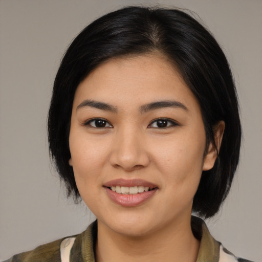 Joyful latino young-adult female with medium  black hair and brown eyes