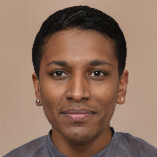 Joyful black young-adult male with short  black hair and brown eyes