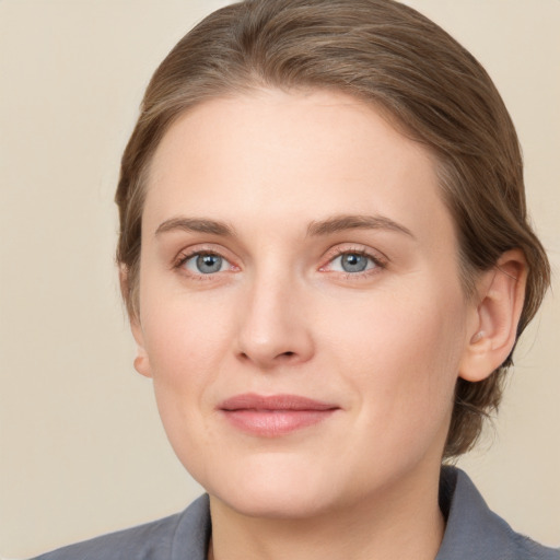 Joyful white young-adult female with medium  brown hair and grey eyes