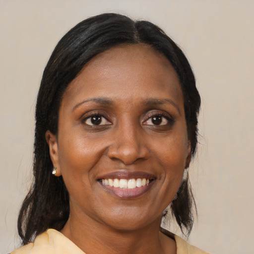 Joyful black adult female with medium  black hair and brown eyes
