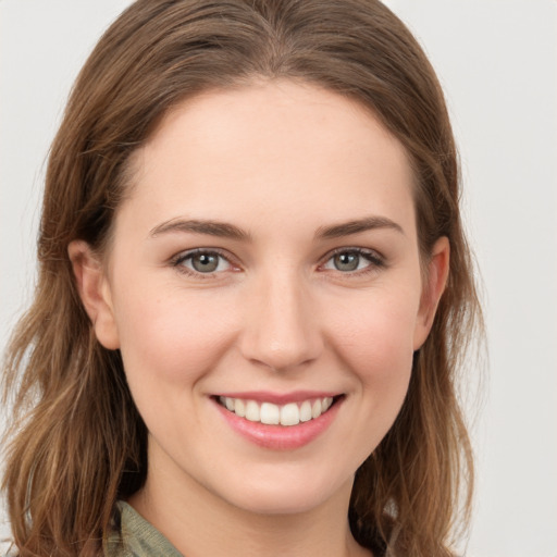 Joyful white young-adult female with long  brown hair and grey eyes