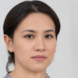 Joyful white young-adult female with medium  brown hair and brown eyes