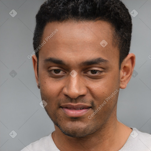 Joyful black young-adult male with short  black hair and brown eyes