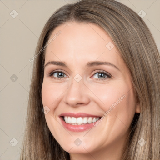 Joyful white adult female with long  brown hair and brown eyes