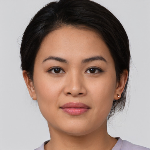 Joyful latino young-adult female with medium  brown hair and brown eyes