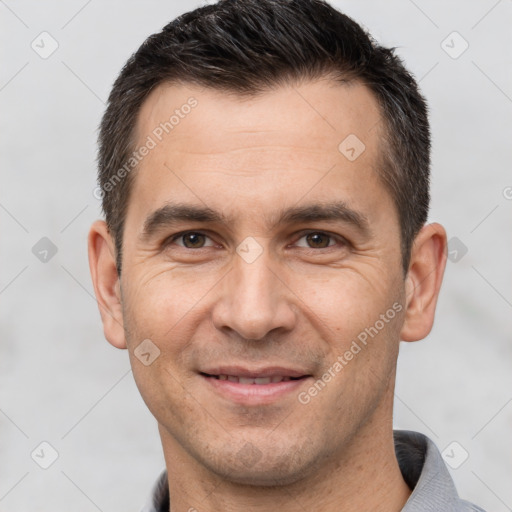 Joyful white adult male with short  brown hair and brown eyes