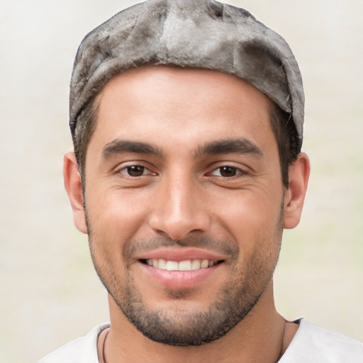 Joyful white young-adult male with short  black hair and brown eyes