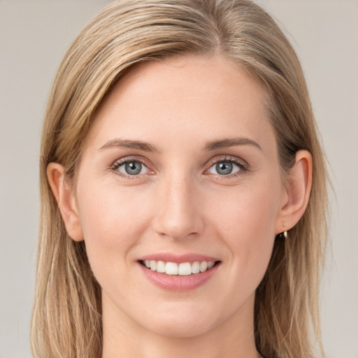 Joyful white young-adult female with long  brown hair and blue eyes