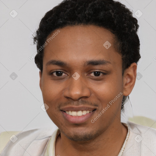 Joyful black young-adult male with short  black hair and brown eyes