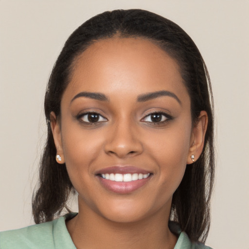 Joyful latino young-adult female with long  black hair and brown eyes