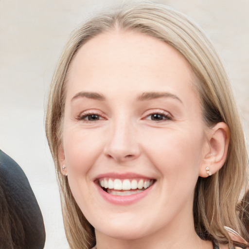 Joyful white young-adult female with long  brown hair and blue eyes