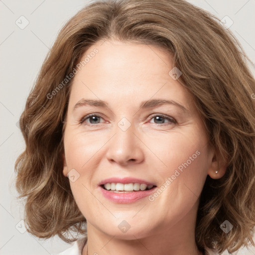 Joyful white young-adult female with medium  brown hair and green eyes