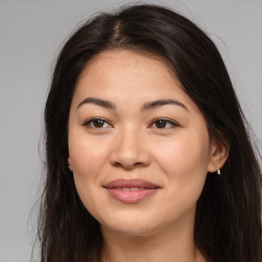 Joyful asian young-adult female with long  brown hair and brown eyes