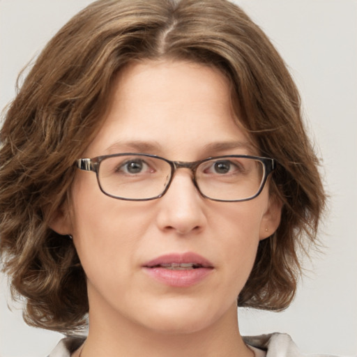 Joyful white adult female with medium  brown hair and green eyes