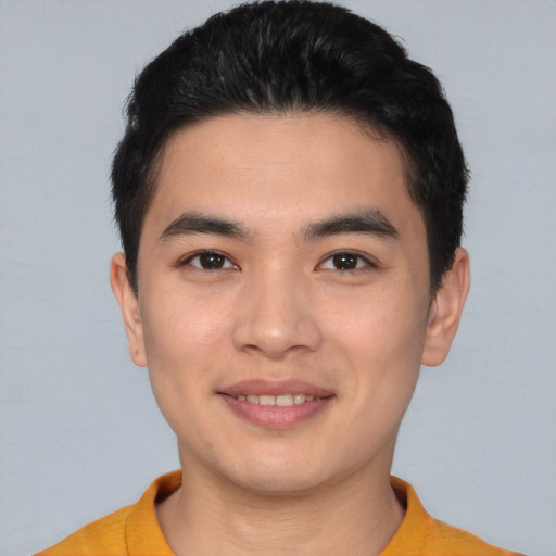 Joyful asian young-adult male with short  brown hair and brown eyes