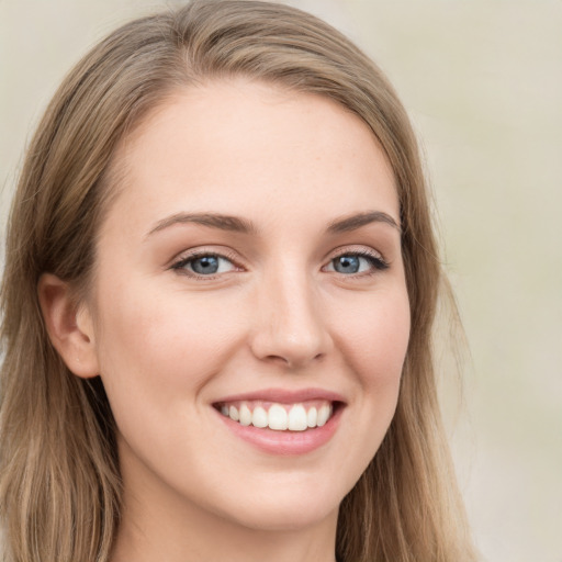 Joyful white young-adult female with long  brown hair and green eyes