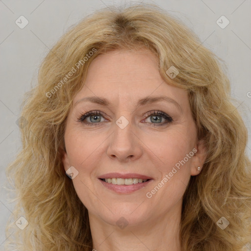 Joyful white adult female with long  brown hair and brown eyes