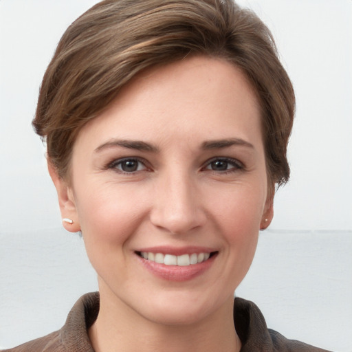 Joyful white young-adult female with short  brown hair and grey eyes