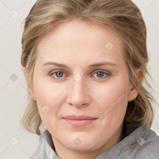 Joyful white young-adult female with medium  brown hair and blue eyes