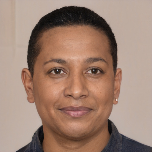 Joyful latino adult male with short  black hair and brown eyes
