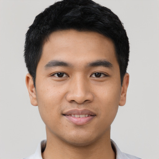 Joyful asian young-adult male with short  black hair and brown eyes