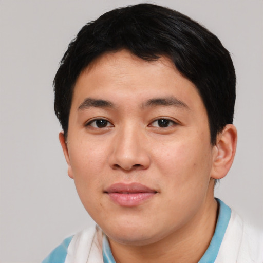 Joyful asian young-adult male with short  black hair and brown eyes