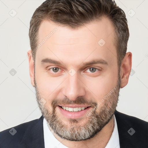 Joyful white adult male with short  brown hair and brown eyes